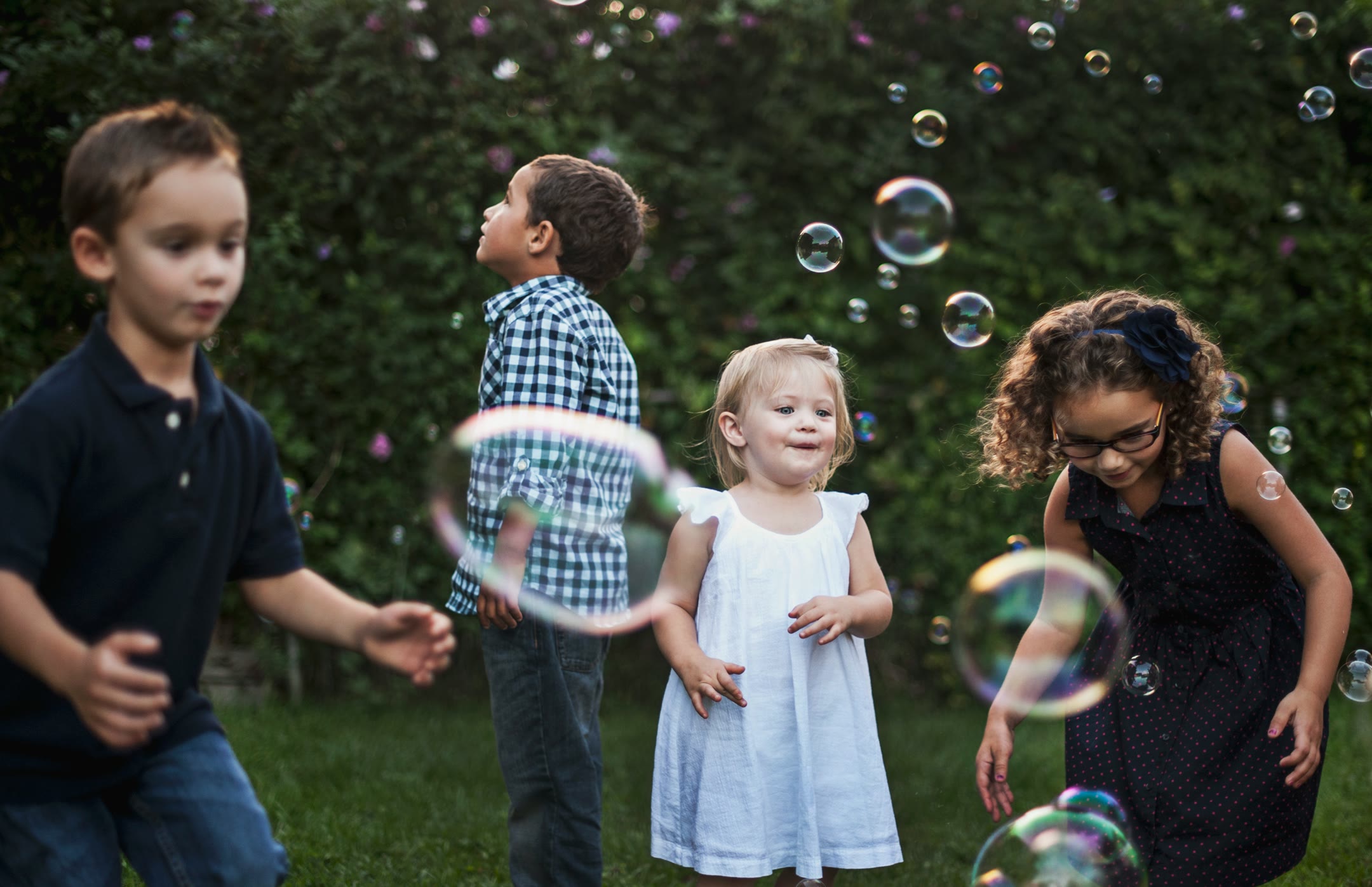 katherine-hanlon-xaG8oaZD7ss-unsplash-optimized Children blowing bubbles and enjoying chasing them